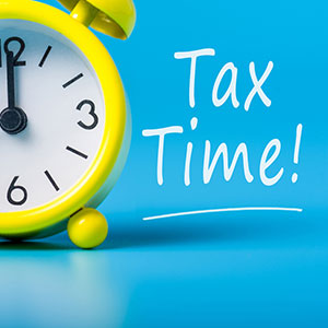 yellow alarm clock and words Tax Time! next to it